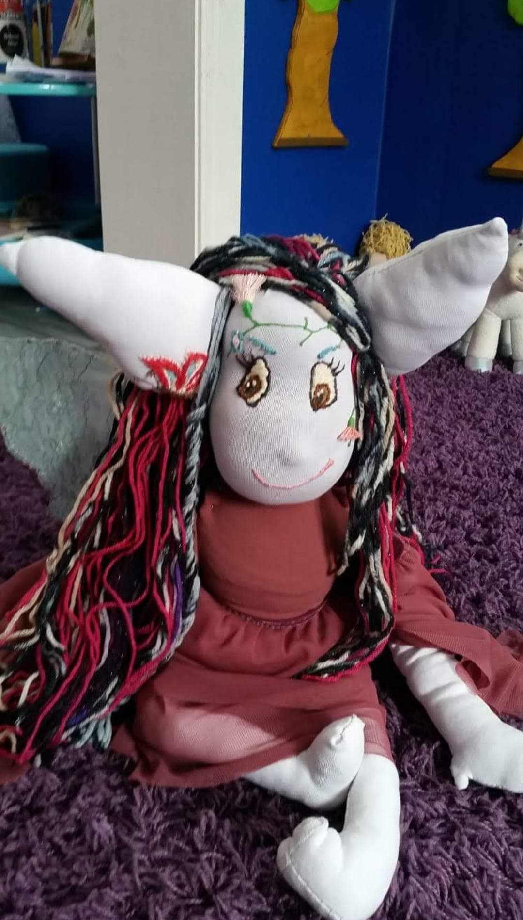 Blume doll resting on a bed